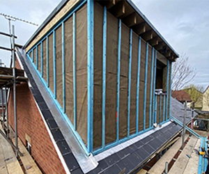 Surveyor assessing loft structure and roof height